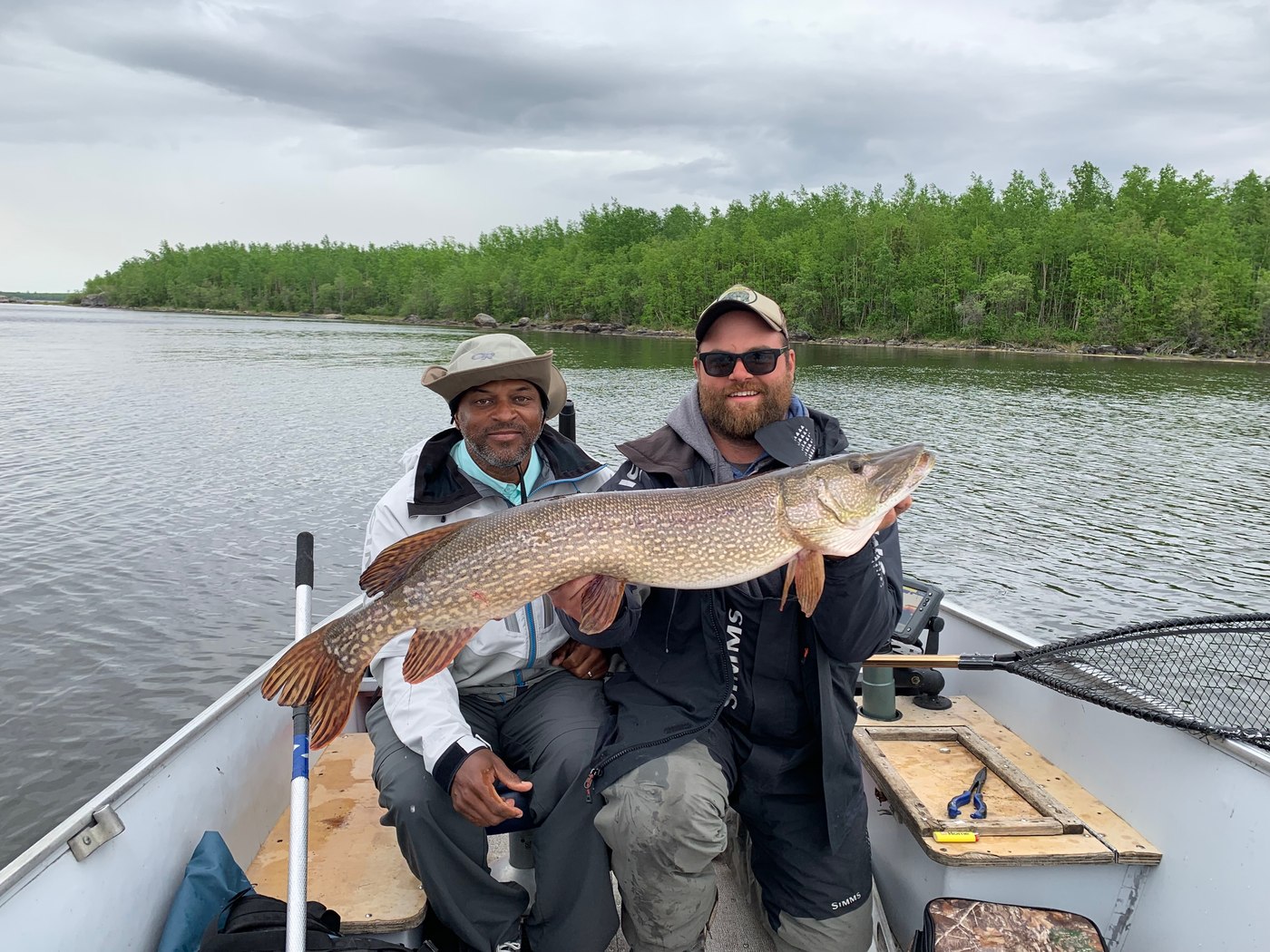 Ty and a fishing companion holding a catch on Bolton Lake, Manitoba, June 2019